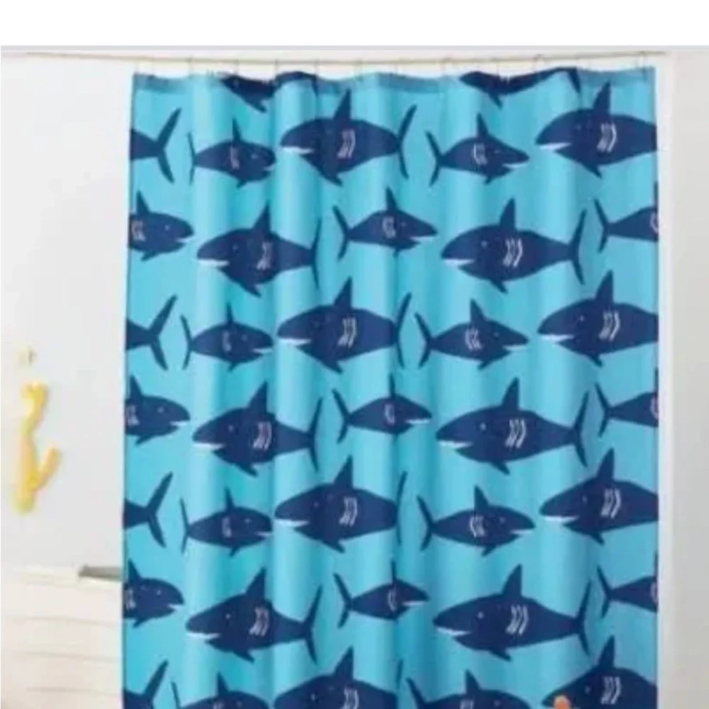 Pillowfort brand shark shower curtain and matching whale faucet cover.